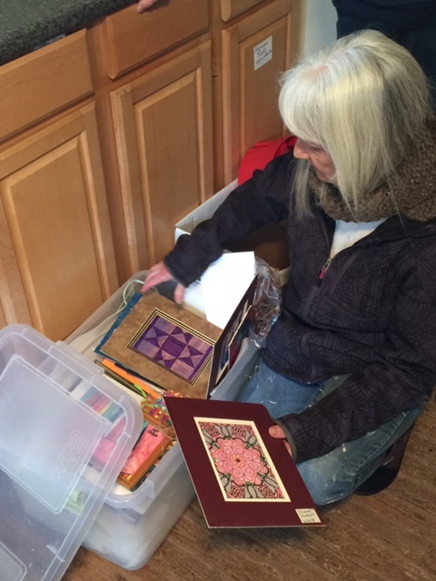 Carol West keeps the art made by each child in
                their own box at the Farm